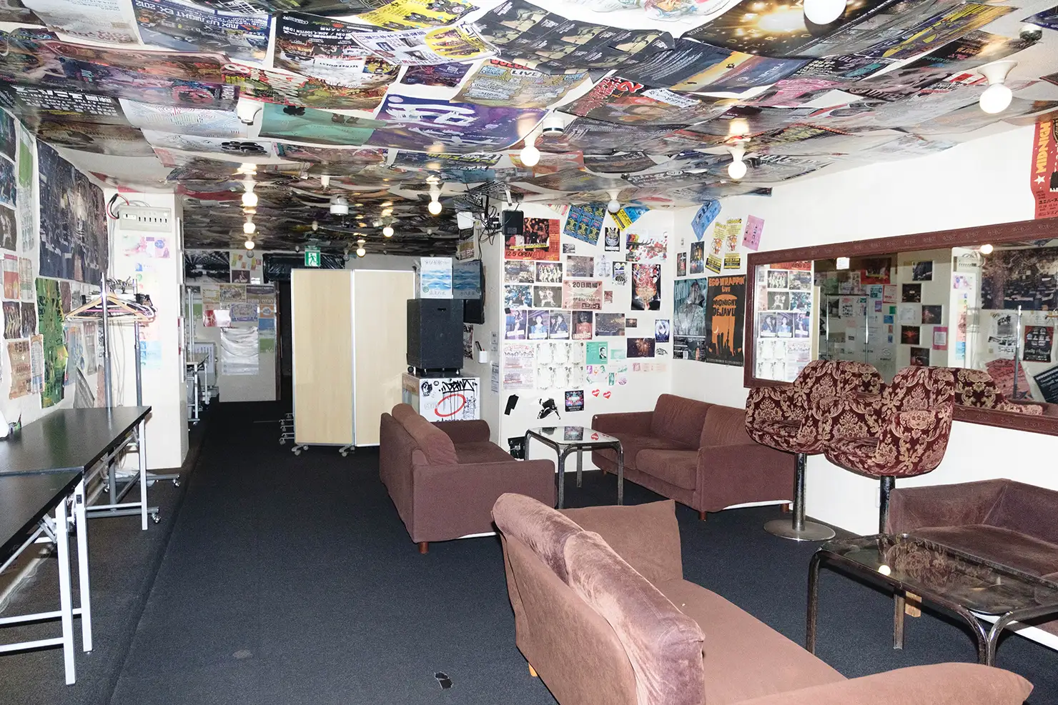 味園ユニバースの楽屋。無数のフライヤーが地層のように重ね張りされている
